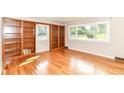 Bright living room with hardwood floors, built-in bookcases, and large windows at 11603 Peacock Dr, Indianapolis, IN 46236