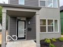 Stylish gray home featuring a covered entryway, modern lighting, and a contemporary design at 1215 Herbert St, Indianapolis, IN 46202
