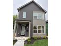 Charming two-story home featuring gray siding, a covered porch, and contemporary design elements at 1215 Herbert St, Indianapolis, IN 46202