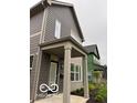 Attractive two-story home with a covered porch, gray siding, and modern architectural details at 1215 Herbert St, Indianapolis, IN 46202