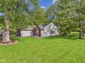 View of the side and backyard of the home, showcasing a spacious, well-kept lawn at 1356 S Catamaran Cir, Cicero, IN 46034