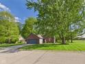 Lovely brick home with an attached garage and a beautiful, expansive front yard at 1356 S Catamaran Cir, Cicero, IN 46034