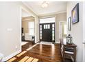 Welcoming foyer with hardwood floors, decorative lighting, and a view into the adjacent living spaces at 14003 Grannan Ln, Carmel, IN 46074