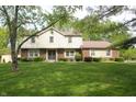 Inviting two-story home featuring a well-kept lawn, brick accents, and manicured landscaping at 15203 Shoreway Ct, Carmel, IN 46032