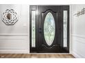 Elegant front door features decorative glass panel and side lights at 15203 Shoreway Ct, Carmel, IN 46032