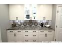 Beautiful kitchen with white cabinets, black hardware, mosaic backsplash and granite countertops at 15203 Shoreway Ct, Carmel, IN 46032