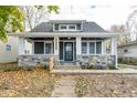 Inviting covered porch with stone base, providing a cozy and relaxing space at 1921 N Dexter St, Indianapolis, IN 46202