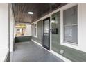 View of the spacious front porch with new lighting fixture and a new black screen door at 1921 N Dexter St, Indianapolis, IN 46202