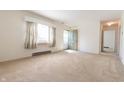 Bright living room with neutral carpet and a view to the front door at 1932 Central Ave, Columbus, IN 47201