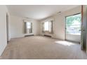 Spacious living room with natural light, neutral carpet, and access to the outdoors at 1932 Central Ave, Columbus, IN 47201