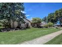 Well-maintained home with lush front yard, mature trees, and a charming brick facade, nestled in a tranquil neighborhood at 2204 Center Dr, Lebanon, IN 46052
