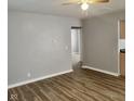 Bright living room with laminate floors, neutral walls and a modern ceiling fan at 2324 E 36Th St, Indianapolis, IN 46218