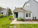 Inviting two-story home with well-maintained lawn and landscaped garden beds leads to a charming green front door at 2829 Somerset Bay, Indianapolis, IN 46240