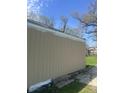 View of the home's side exterior showcasing the siding and yard at 3242 Collier St, Indianapolis, IN 46221