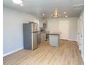 Bright kitchen featuring stainless appliances, an eat-in island, light gray cabinets and modern finishes throughout at 3411 Chase St, Indianapolis, IN 46217
