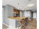 Charming kitchen features a peninsula with stools and stainless steel appliances at 350 N Meridian N St # 701, Indianapolis, IN 46204