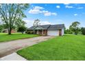 Lovely brick home featuring a spacious lawn and a driveway leading to the attached garage at 374 S Baldwin St, Bargersville, IN 46106