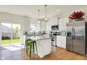 Modern white kitchen with stainless steel appliances, marble countertops, and a bright, airy feel at 49 Manchester Dr, Trafalgar, IN 46181