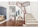 Elegant foyer with hardwood floors, staircase, and stylish decor at 4956 Waterside Cir, Carmel, IN 46033