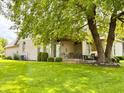 Expansive backyard featuring a large tree, patio, and lush green grass, creating a perfect outdoor retreat at 5190 Pursel Ln, Carmel, IN 46033