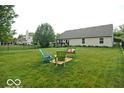 Expansive fenced backyard with lush green grass and comfortable seating arrangement at 533 Charnwood Pkwy, Beech Grove, IN 46107
