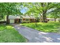 Quaint brick home with attached garage, set back on a deep grassy lot at 5840 Brouse Ave, Indianapolis, IN 46220