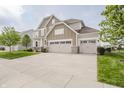 Charming two-story home featuring a large driveway and well-maintained lawn at 6101 Hardwick Dr, Whitestown, IN 46075