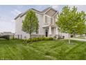 Two story home with tidy landscaping and a well-maintained lawn at 6101 Hardwick Dr, Whitestown, IN 46075