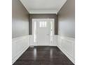 Inviting foyer featuring dark hardwood floors, decorative molding and neutral wall paint at 6101 Hardwick Dr, Whitestown, IN 46075