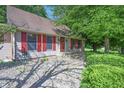 Exterior shot of a home with red shutters and landscaping, enhanced by a stone walkway at 6334 Teak Ct, Indianapolis, IN 46217