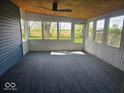 The sun room has multiple large windows and carpeted floor at 706 Alexander St, Greenwood, IN 46143