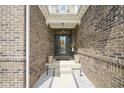 Inviting front entryway with brick walls, potted plants, and a decorative door at 7632 Nestucca Trl, Noblesville, IN 46062