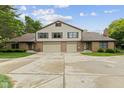 A beautiful two-story home featuring a two-car garage, brick accents, and well-maintained lawn at 774 Chapel Pines W Dr, Indianapolis, IN 46234