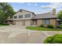 This home has a brick facade, two-car garage, lush lawn, and concrete driveway at 774 Chapel Pines W Dr, Indianapolis, IN 46234