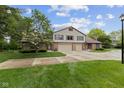 Charming home features a brick facade, two-car garage, a well-kept lawn and sidewalk at 774 Chapel Pines W Dr, Indianapolis, IN 46234