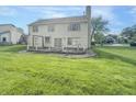 The large backyard features a wooden deck, ideal for outdoor dining at 817 Timber Creek Dr, Indianapolis, IN 46239
