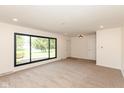 Bright living room featuring neutral carpet and large window with black trim at 8415 Los Robles Rd, Fishers, IN 46038