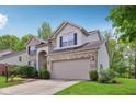 Beautiful home featuring manicured lawn and landscaping and an attached 2-car garage with a driveway at 8745 Providence Dr, Fishers, IN 46038