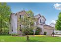 Lovely single Gathering home with a brick facade, large windows and well maintained lawn and landscaping at 8745 Providence Dr, Fishers, IN 46038