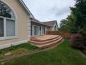 The backyard boasts a lovely wooden deck, perfect for relaxing or entertaining guests at 9640 Bramblewood Way, Carmel, IN 46032