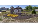 Beautiful community entrance sign displays 'Cedar Ridge' with flowers and professional landscaping at 1018 Cyprian Way, Lebanon, IN 46052
