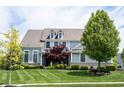 Charming two-story home with a well-maintained lawn and mature trees at 10291 Normandy Way, Fishers, IN 46040