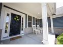 Inviting front porch with rocking chairs and stylish front door décor at 10291 Normandy Way, Fishers, IN 46040