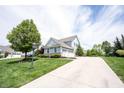 Spacious three-car garage with a long driveway and lush landscaping at 10291 Normandy Way, Fishers, IN 46040