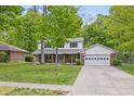 Charming two-story home with a brick facade, a covered front porch, and a well-maintained lawn at 10429 Lasalle Rd, Carmel, IN 46033