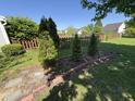 A fenced backyard with landscaping and mature trees at 11163 Autumn Harvest Dr, Fishers, IN 46038