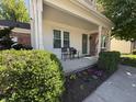 Cozy front porch with seating and colorful flowerbeds enhancing the home's curb appeal at 11163 Autumn Harvest Dr, Fishers, IN 46038