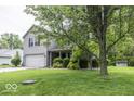 Two-story home features mature trees, an attached two-car garage, and a green lawn at 1119 Albemarle Cir, Noblesville, IN 46062