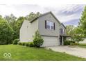 Well-maintained two-story home featuring an attached garage and a lush green lawn at 1119 Albemarle Cir, Noblesville, IN 46062