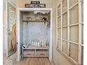 Mud room entry with coat rack, bench, and charming decor at 116 E Railroad St, Fountaintown, IN 46130